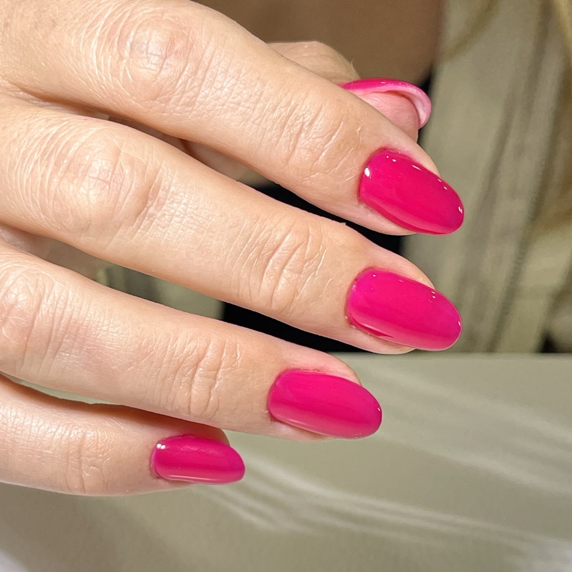 Vibrant glossy fuchsia almond-shaped nails